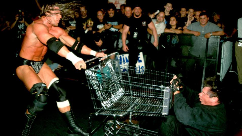  Triple H hits Vince with a shopping trolley