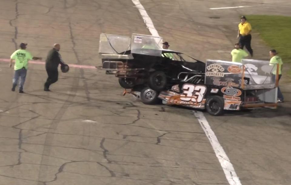 Shawn Cullen takes off his helmet after his opponent drove on top of his car