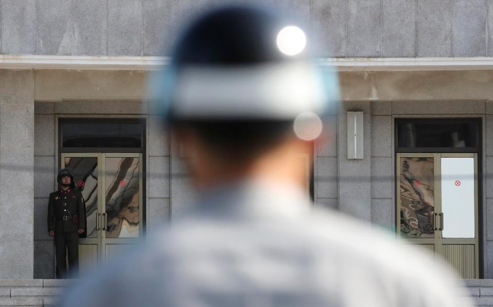  A South Korean (centre) soldier stands guard at the Demilitarized Zone (DMZ) in the border village of Panmunjom, South Korea
