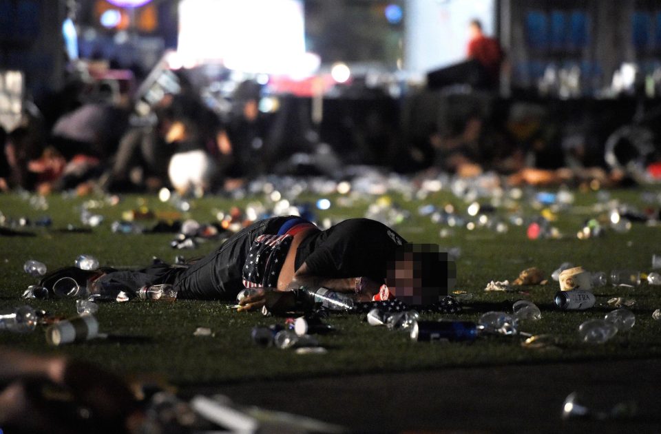 A man lies on the ground, covered in blood after the shooting