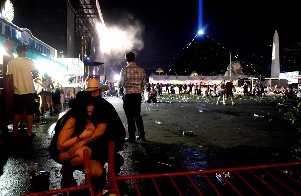  A man holds a terrified woman in his arms as they duck for cover