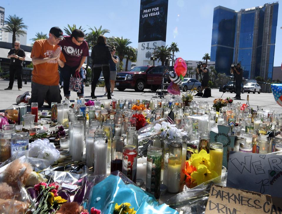 Tributes to those who lost their lives are seen laid out on the pavement 