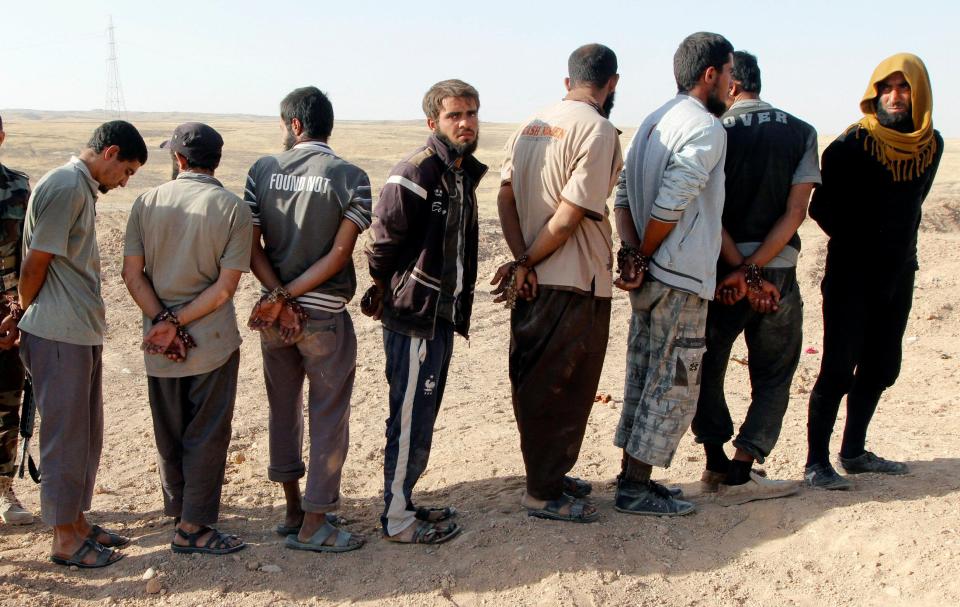  Islamic State militants are seen lined-up after being detained