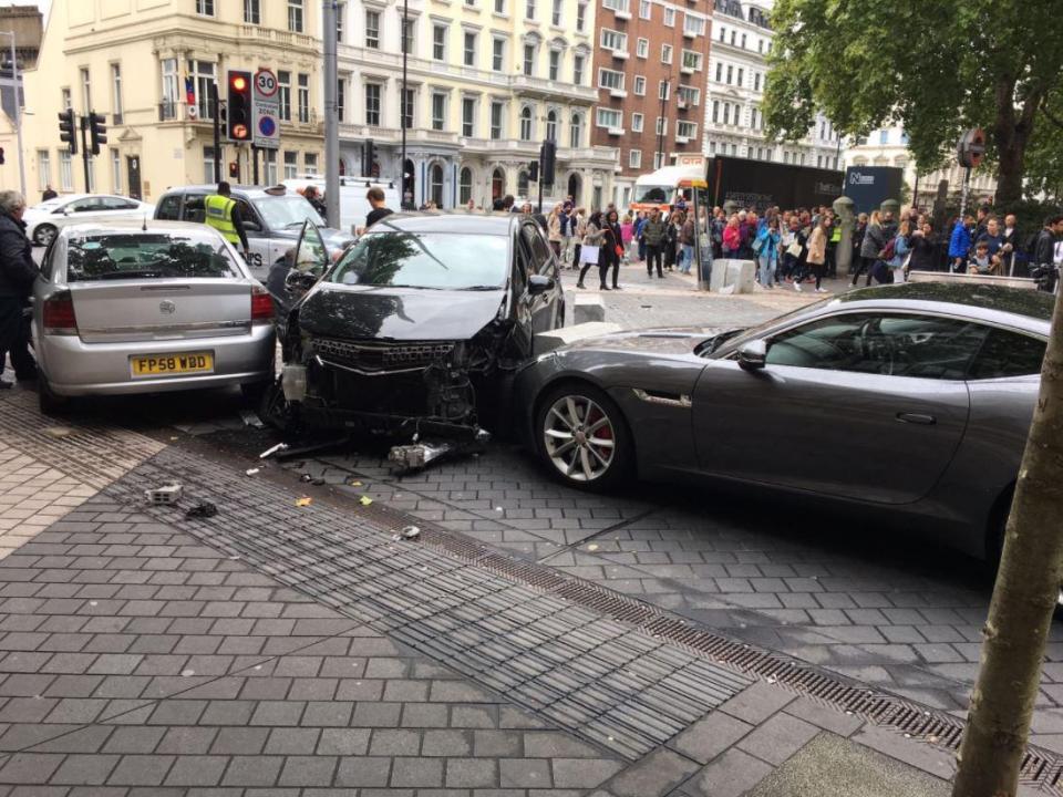  Three cars can be seen in the collision with debris spread across the road