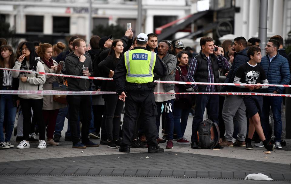  Police can be seen holding back crowds who are waiting at the cordon