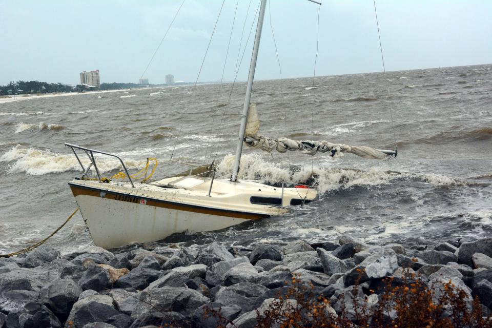  An abandoned boat takes on water on the Mississippi Gulf Coast