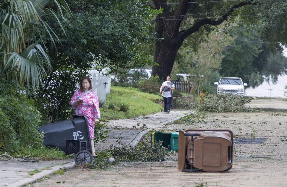  Biloxi residents venture out just after dawn to survey the damage after the eye of Hurricane Nate made its second landfall