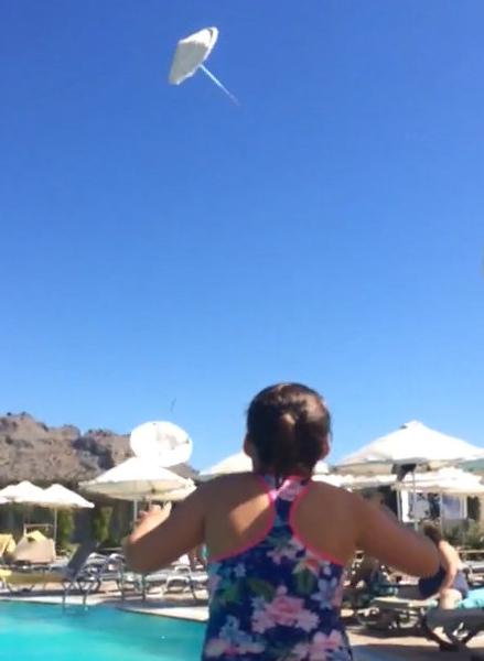  Parasols were sent hundreds of feet up into the air after a mini tornado hit a Greek holiday resort