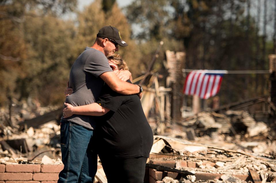  A couple embrace in front of their burned home in Santa Rosa, California