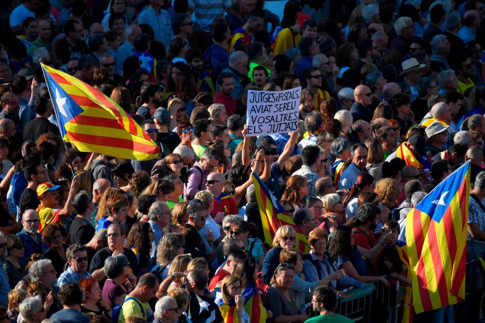  Protesters held up signs and flags as they marched against the announcement made by the Spanish Prime Minister