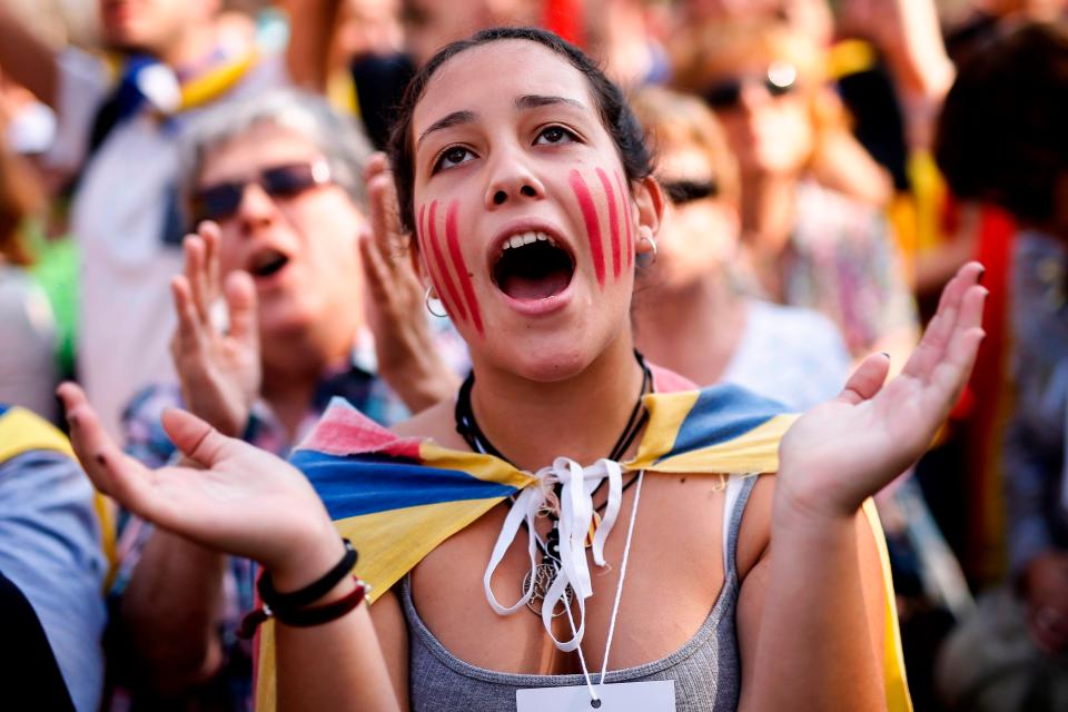  A young woman celebrates outside the Catalan parliament in Barcelona