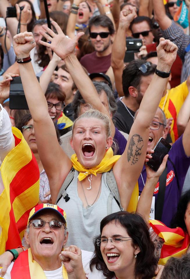  People celebrate after the Catalan regional parliament passes the vote of independence from Spain