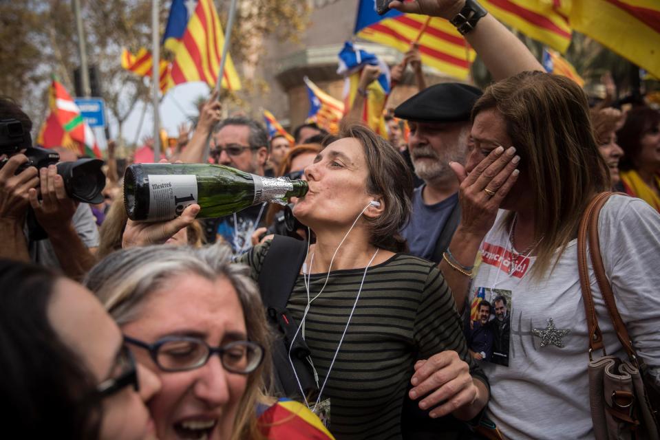  A woman drinks from a bottle of wine in celebration of the controversial vote
