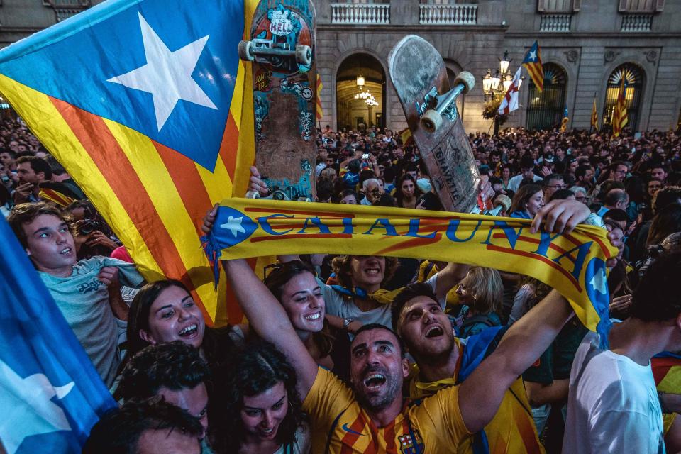  A man wearing a Barcelona strip celebrates with hundreds more despite the controversy surrounding the vote