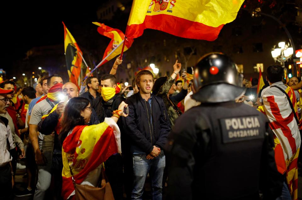  A Catalan riot police stands as anti-independence supporters march against the landmark vote