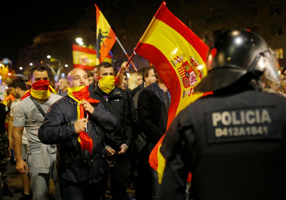  Holding Spanish flags, demonstrators confront Catalan police