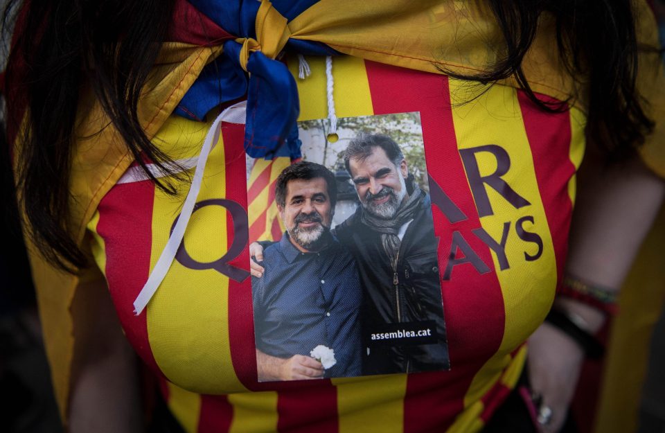  A Catalan supporter displays a portrait of Jordi Sanchez and Jordi Cuixart, two key members of the independence movement