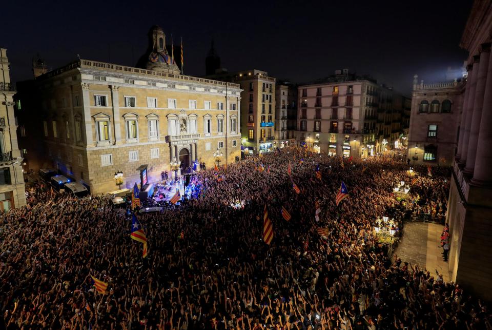  People raise arms as they gather during celebrations in Sant Jaume square