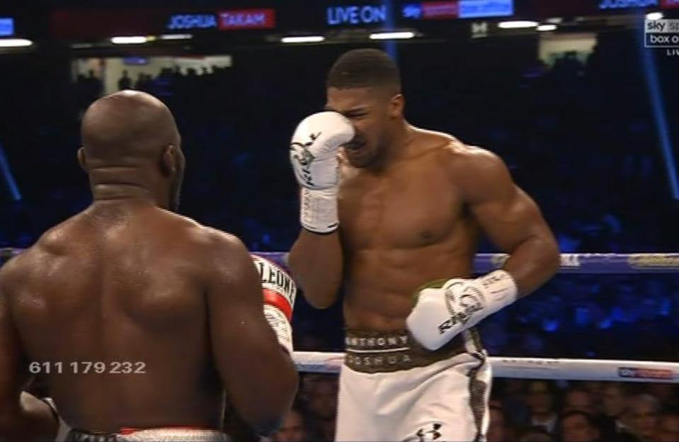  Anthony Joshua holds his nose after Carlos Takam's head-butt