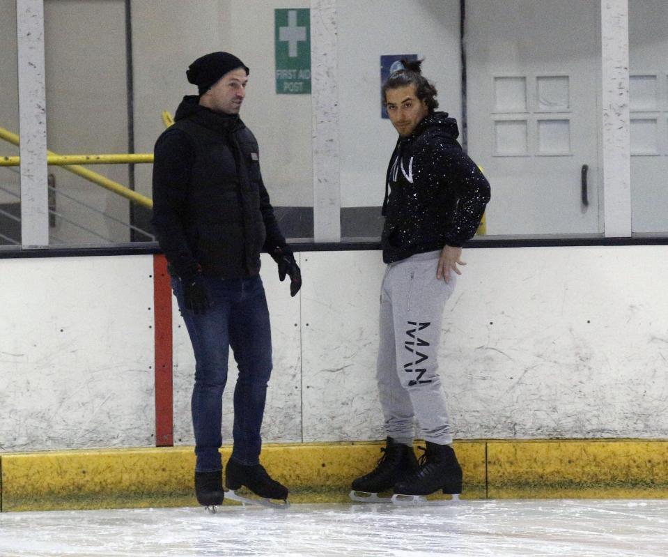  Kem and his trainer chatted through tac-tics as they watched the others on the ice