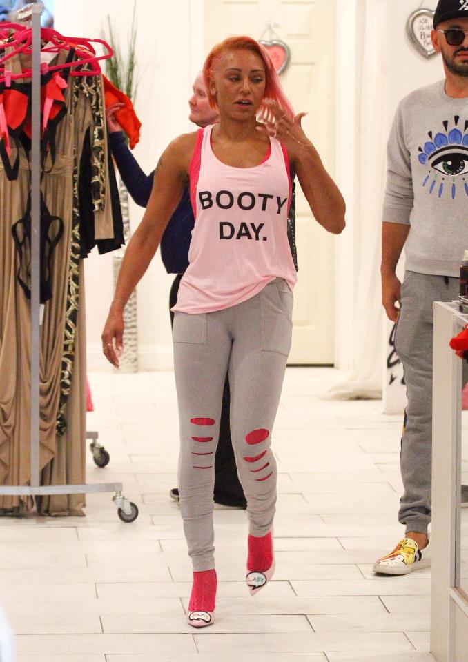  Booty Day! Mel tried on a provocative, sleeveless top - and some ripped grey leggings. She was wearing long, pink socks with a pair of pink high heels.