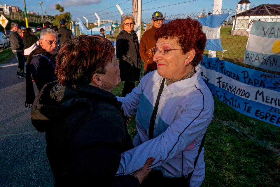 Maria Rosa Belenstro, right, mother of missing submariner Fernando Villareal, is comforted by a local woman outside Argentina's Navy base in Mar del Plata