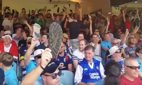 England fans show security staff what they think after a fan is told to put his shoe back on