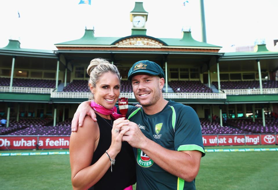  David Warner and his partner Candice pose with the urn in 2014