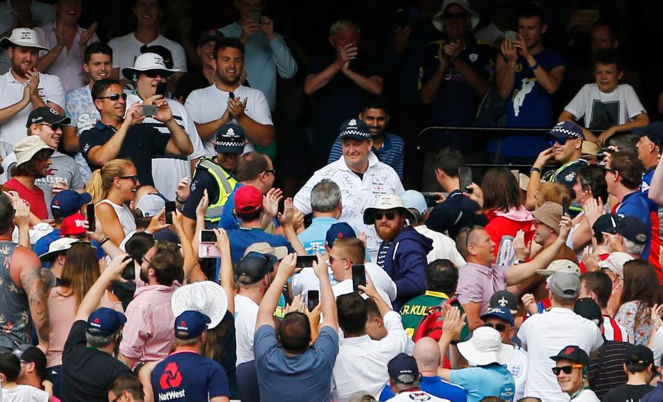 A police officer wears a Barmy Army shirt he was presented with by England fans