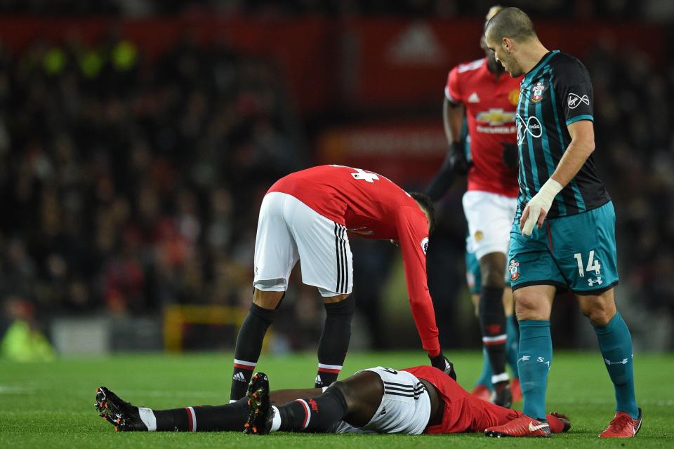  Lukaku lied motionless on the floor as concerned team-mates watched over him