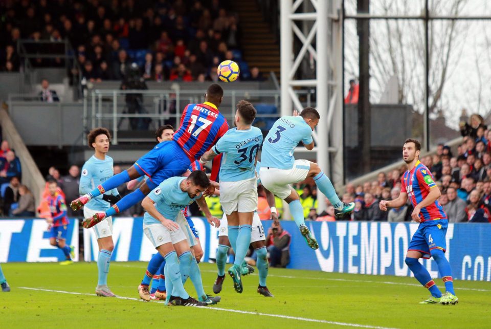  Christian Benteke leaps above the crowd to challenge for a header