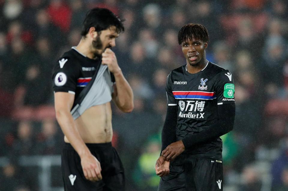 Eagles duo James Tomkins and Wilfried Zaha look dejected after conceding in the first half