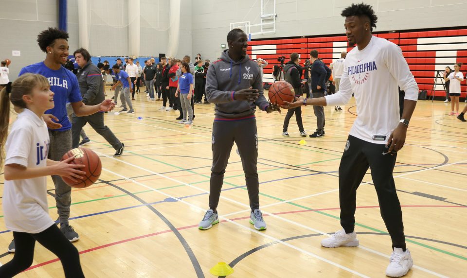  Philadelphia 76ers star Robert Covington teaches Mamadou Sakho of Crystal Palace how to dribble