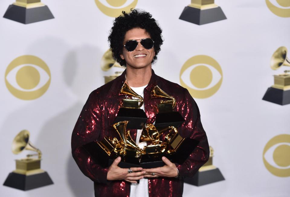 Bruno Mars clutching his six awards at last night's Grammys