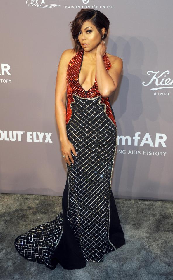  Actress Taraji P Henson dazzled in a low-cut orange and navy gown with sequin detailing