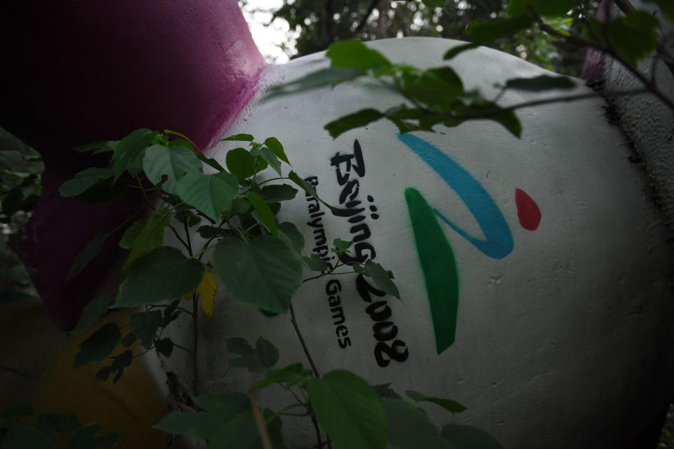  A fallen mascot buried beneath the trees is symbol of what's left as a reminder of Beijing 2008