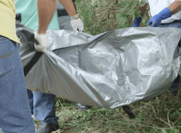  A body bag is used to carry away another victim yards from a beach