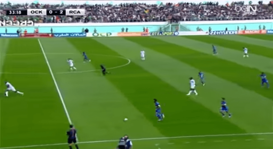 OCK Khouribga player picks up ball in space just inside his own half