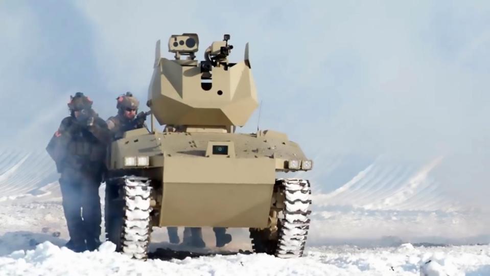 Troops move in behind the robot tank 