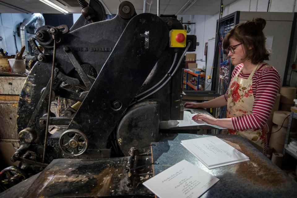  Lottie Small uses the die stamping press at the workshop of Barnard & Westwood in London to make the invitations