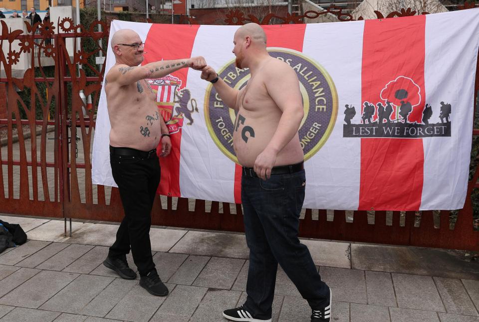 A Sunderland supporter and Newcastle fan greet each other as they attend the FLA march in Birmingham