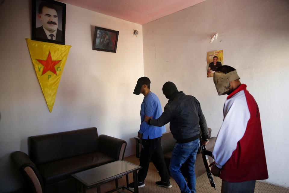 The pair are led to by a Kurdish security officer for the sit-down interview