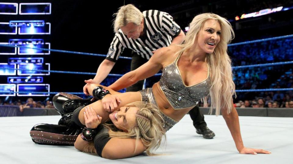  Charlotte locks in the head scissors on struggling Natalya on SmackDown