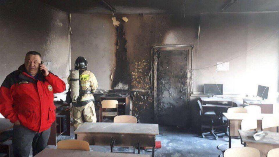  Officials inspect the burnt out classroom after the attack