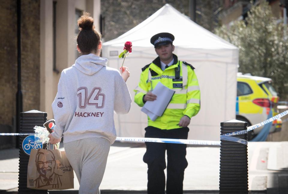  A young woman brings a flower to the spot where Israel was murdered