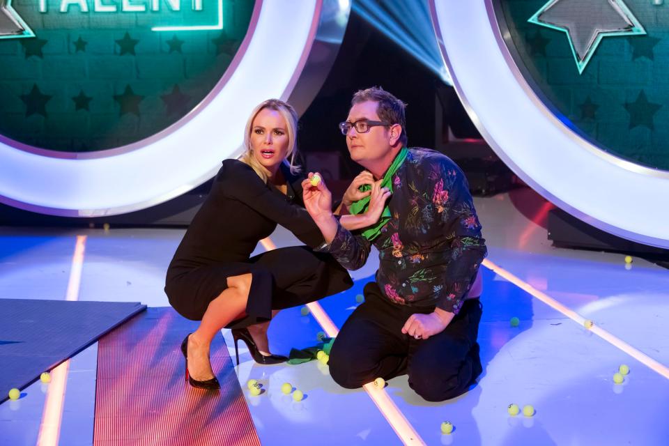  Amanda Holden pours balls into a huge balloon worn by Alan Carr