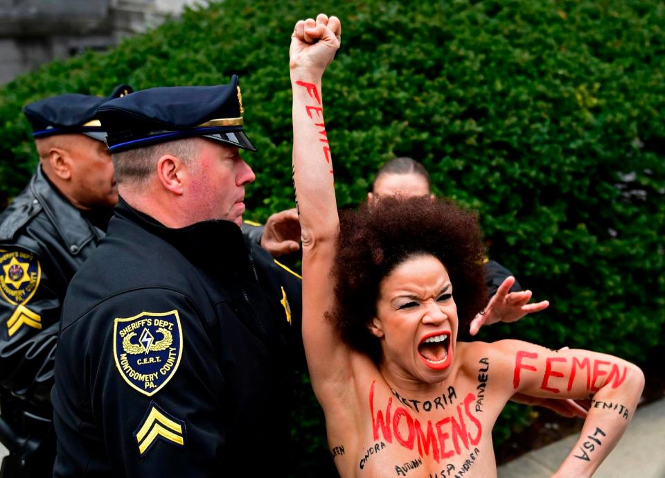 Topless protester Nicolle Rochelle disrupted the Bill Cosby retrial in Philadelphia