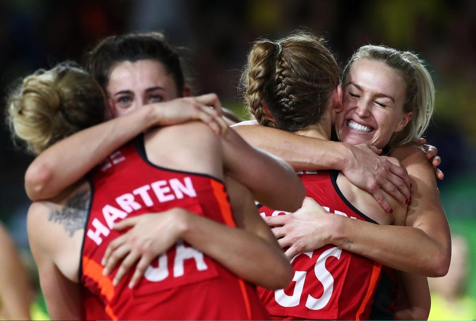  The players embrace following the surprise win at the Commonwealth Games in Australia