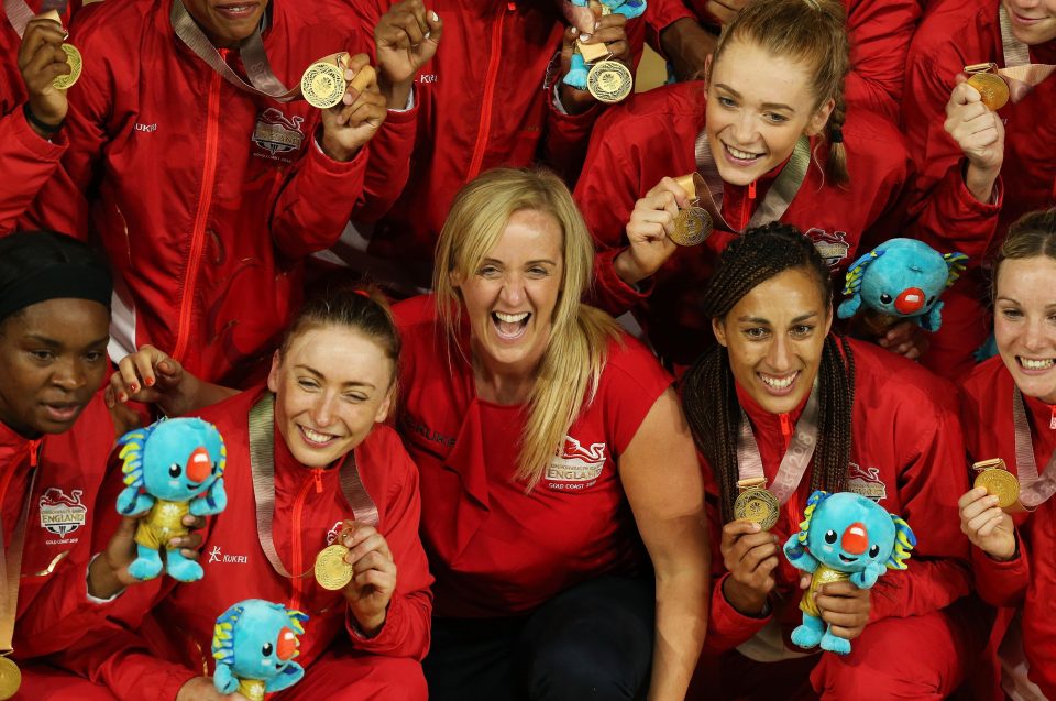 Proud coach Tracey Neville celebrates with players after England won netball gold