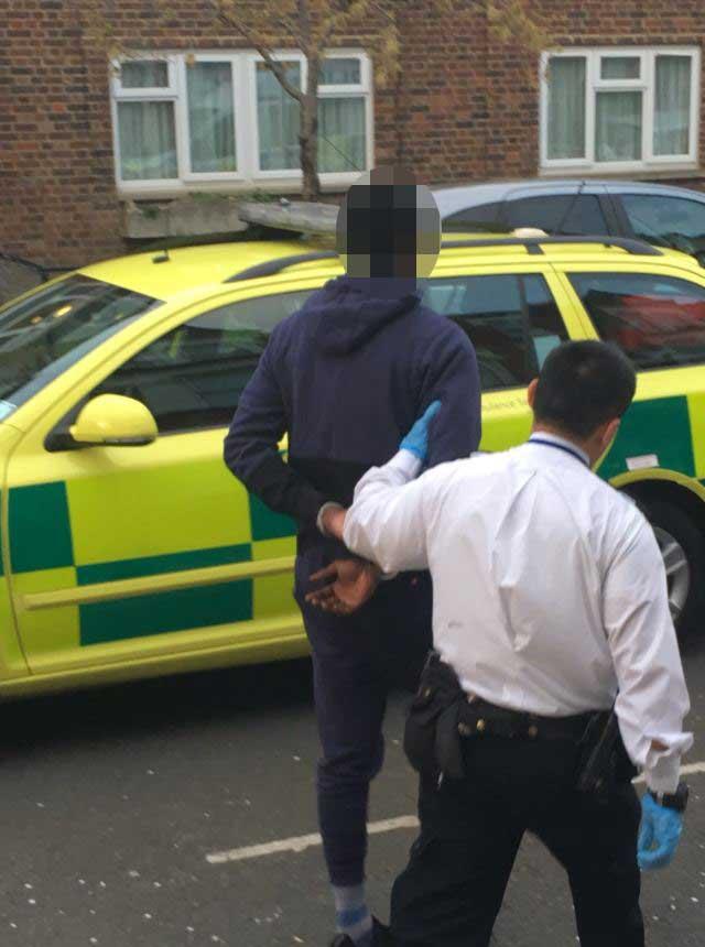  A man is led away by police in Brixton after Samantha Clarke was killed